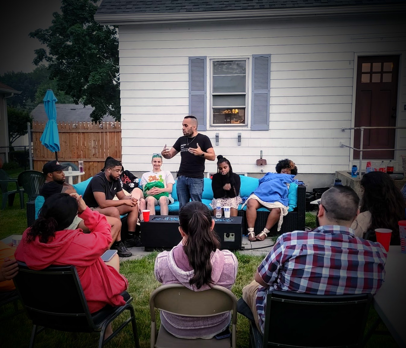 Joshua Luis Pereira speaking to a group at a community gathering